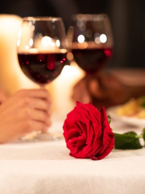 Romantic Evening Date. Hands Clinking Glasses On Served Restaurant Table. Shallow Depth, Selective Focus